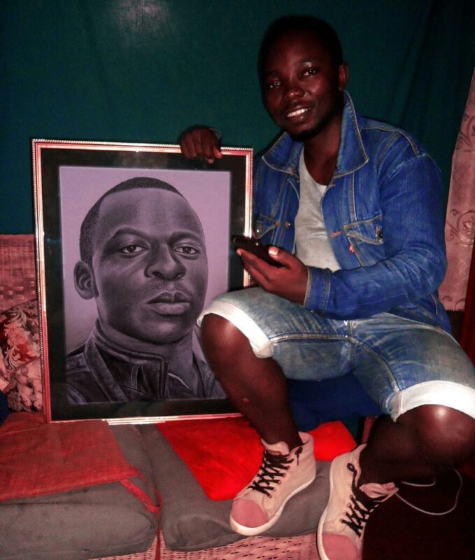 Rapsy posing with one of his drawings